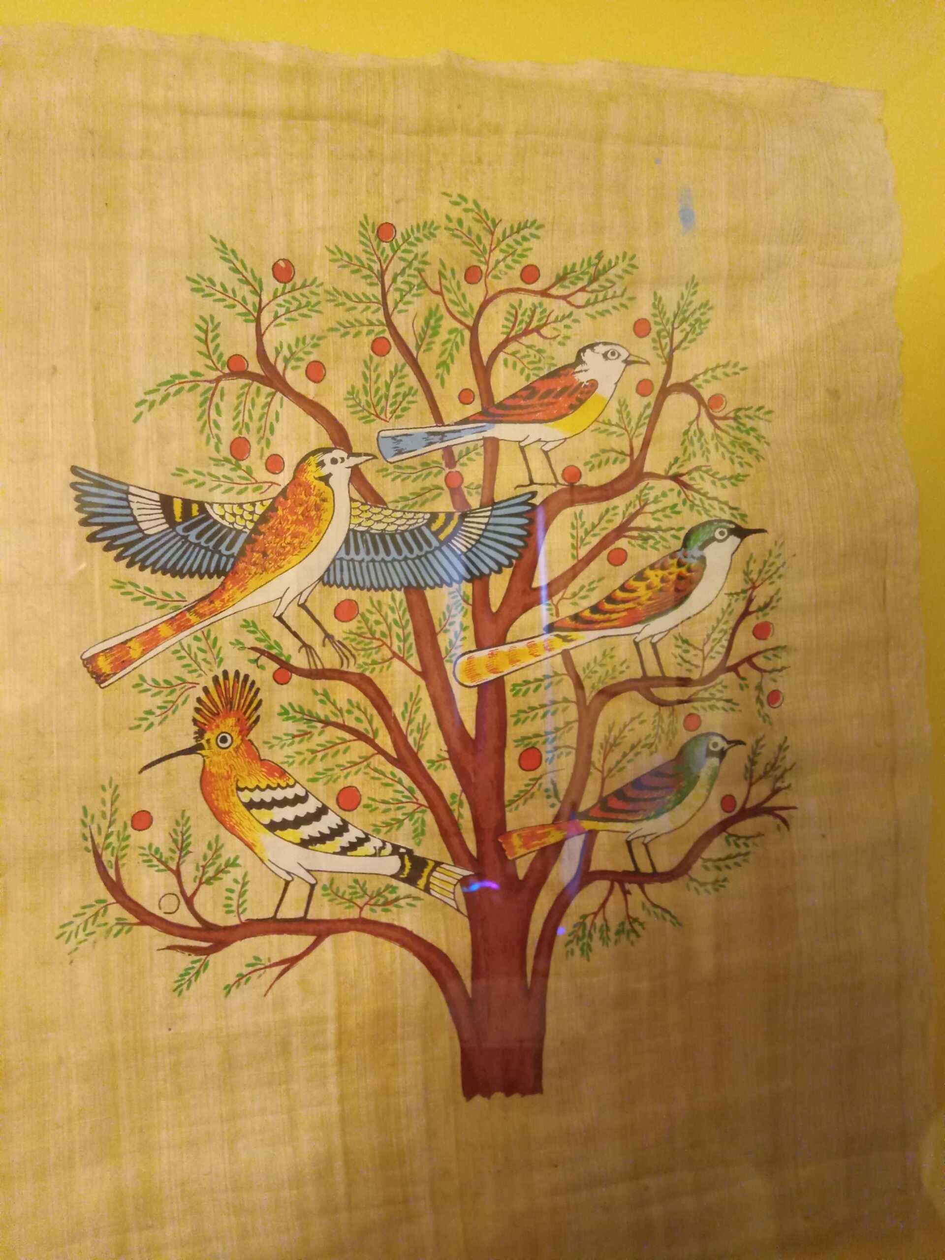 A manuscript painting of birds in a tree.