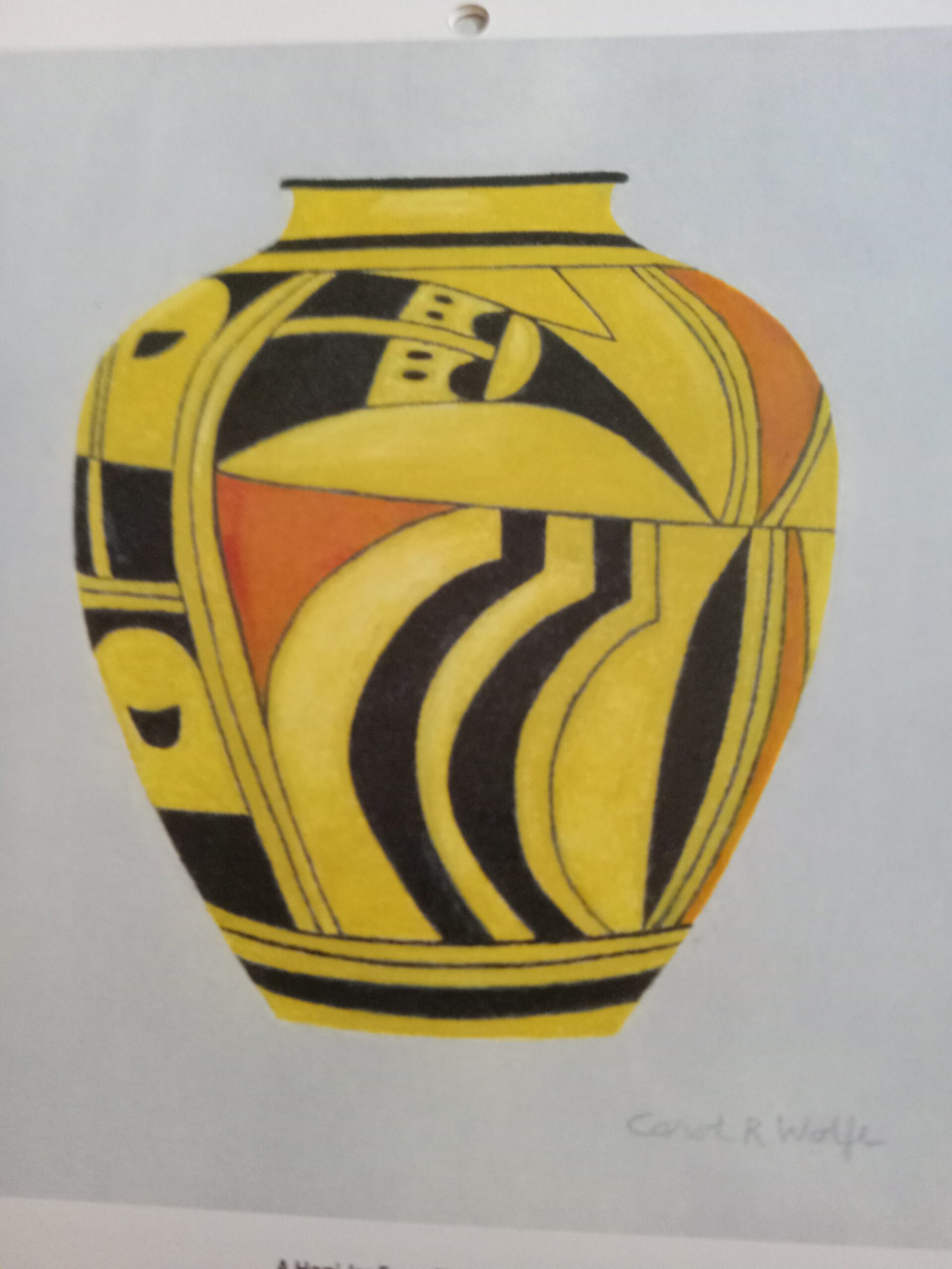 A pottery vase with yellow, orange, and black color by Carol R. Wolfe.